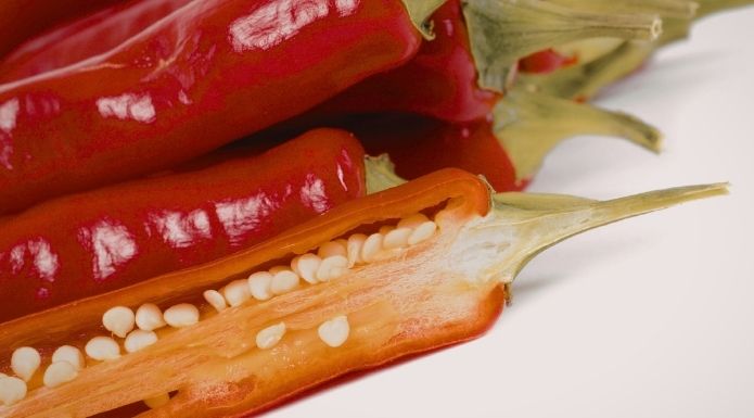 Cross-section of a chili pepper showing the white inner ribs where most of the heat is contained, and seeds.