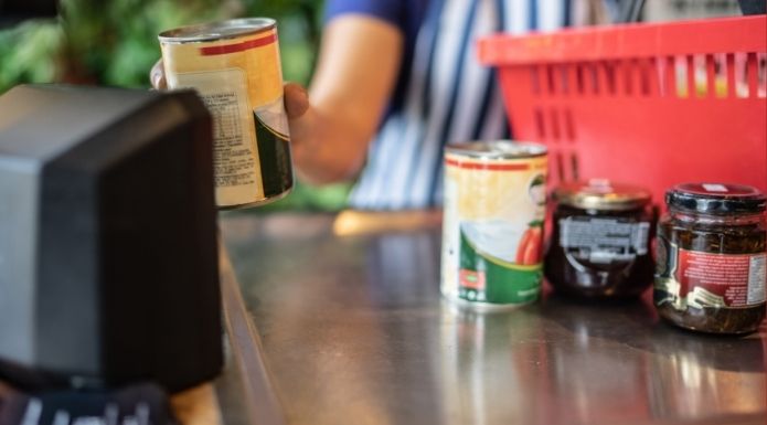 Grocery store cashier scanning grocery items,