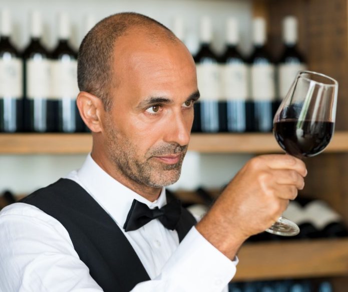 Sommolier examining wine