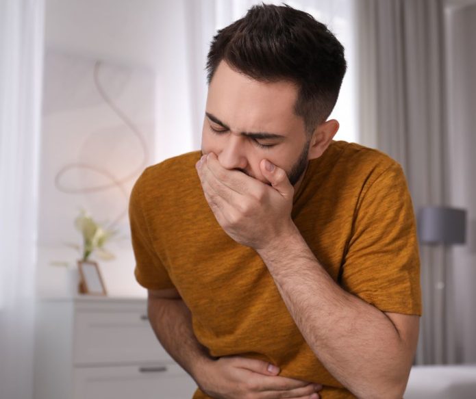 man with food poisoning symptoms