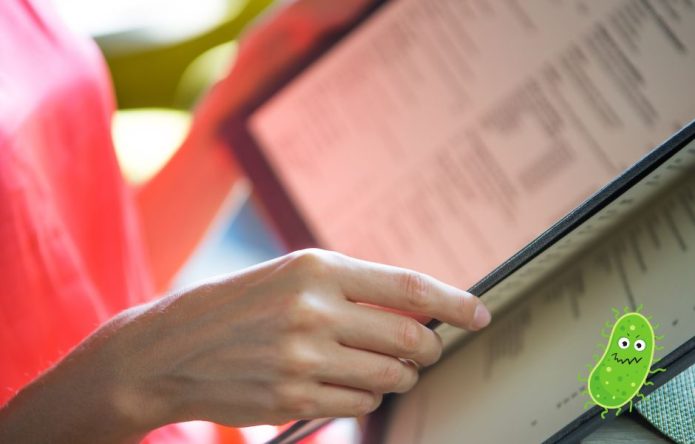customer reading restaurant menu