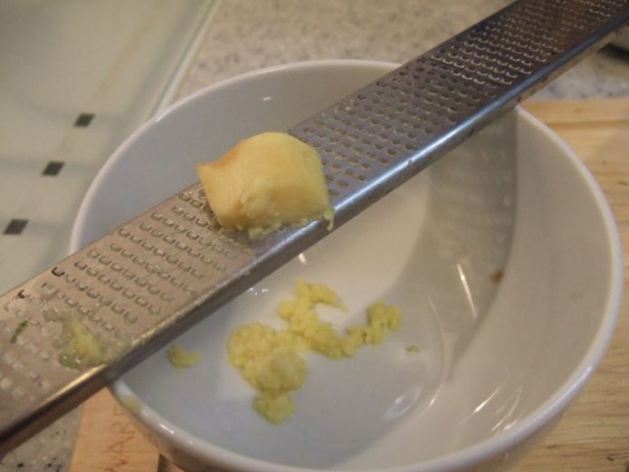 microplane grater being used to zest lemon