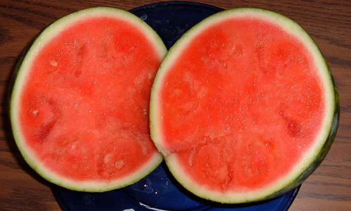 Seedless watermelon sliced in half to show flesh of fruit