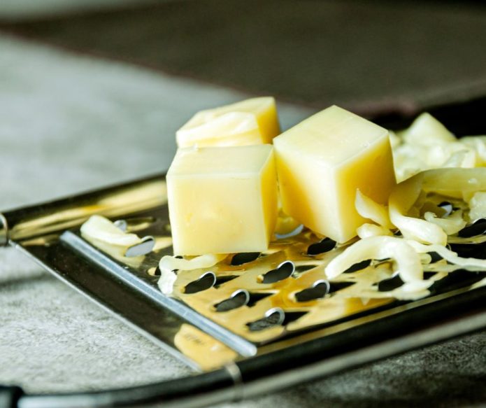 cheese grater with grated cheese