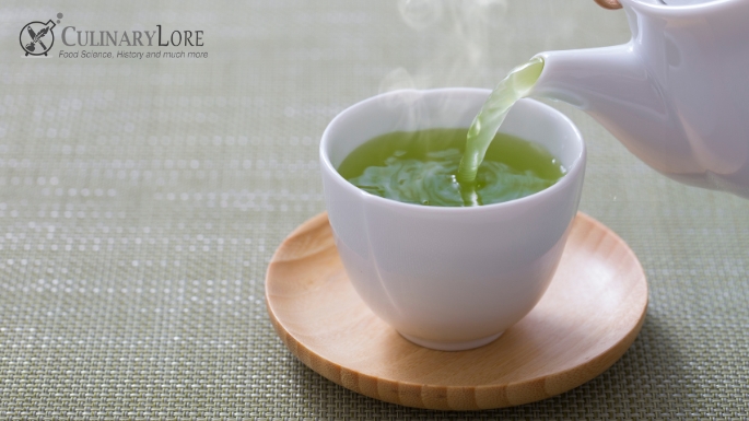 brewed green tea being poured into cup