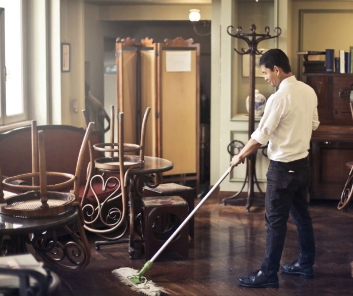 cleaning restaurant floor in dining area
