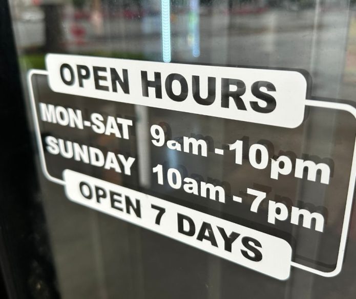 open hours sign on front door