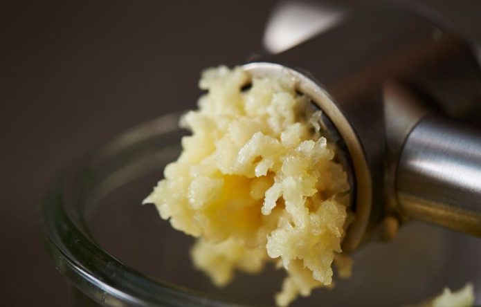 using garlic press closeup