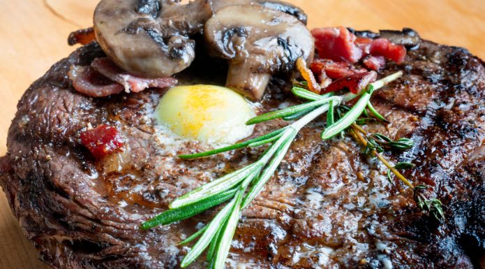 perfectly cooked steak with butter, thyme, and mushrooms