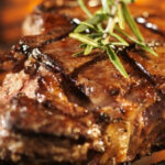 well-done steak, cooked to perfection on grill