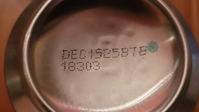 sell-by date stamped on the bottom of Coca-Cola can